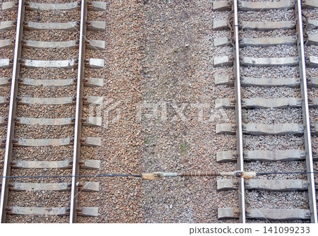 Railway tracks in the city with track bed. Gravel and switch at a railroad crossing. Railway tracks in the city with track bed. Gravel and switch at a railroad crossing. 141099233
