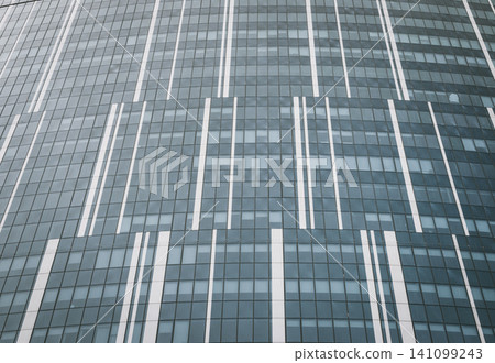 Facade of a tall glass building. Modern abstract architecture Facade of a tall glass building. Modern abstract architecture 141099243