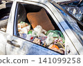 Broken and abandoned old white car. A car with a broken windshie 141099258