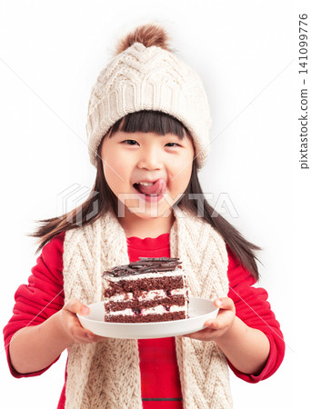Little girl in winter outfit holding a slice of chocolate cake, dessert and birthday celebration concept. Little girl in winter outfit holding a slice of chocolate cake, dessert and birthday celebration concept. 141099776