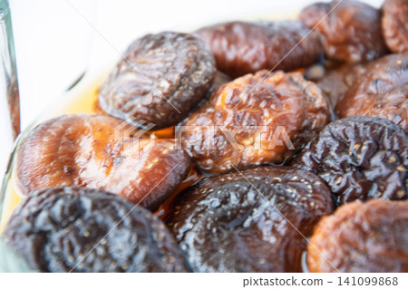 Rehydrating dried shiitake mushrooms Rehydrating dried shiitake mushrooms 141099868