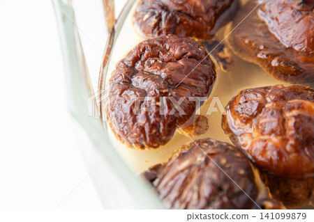 Rehydrating dried shiitake mushrooms Rehydrating dried shiitake mushrooms 141099879