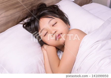Asian little girl sleeping peacefully in bed, healthy sleep and childhood rest concept Asian little girl sleeping peacefully in bed, healthy sleep and childhood rest concept 141099950
