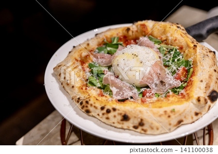 Authentic pizza topped with burrata cheese Authentic pizza topped with burrata cheese 141100038