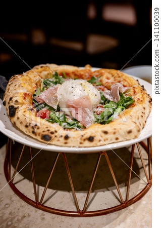 Authentic pizza topped with burrata cheese Authentic pizza topped with burrata cheese 141100039
