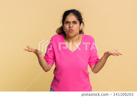 Indian young woman expressing shock and surprise, emotionally spreading hands asking what happened Indian young woman expressing shock and surprise, emotionally spreading hands asking what happened 141100201