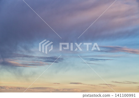 Soft pastel sunset clouds paint the evening sky in gradients. Soft pastel sunset clouds paint the evening sky in gradients. 141100991