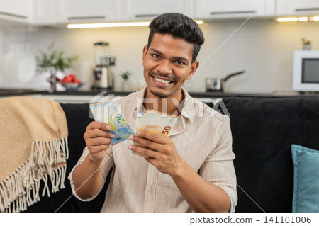 Indian man counts euro cash happy makes money gesture plans dream purchase savings bonus invest plan Indian man counts euro cash happy makes money gesture plans dream purchase savings bonus invest plan 141101006