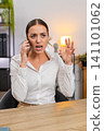 Young businesswoman argues on smartphone waves palm no no shows irritation and raises voice on call 141101062