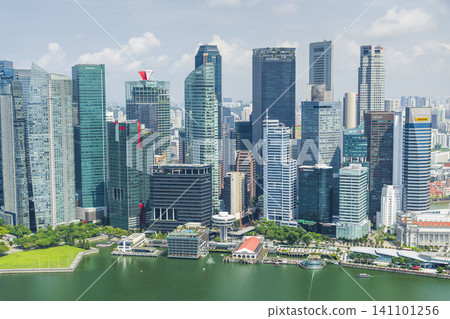 Building view of modern skyscrapers along Marina Bay in the Raffles Place financial district from the Marina Bay Sands Skypark, Singapore. Building view of modern skyscrapers along Marina Bay in the Raffles Place financial district from the Marina Bay Sands Skypark, Singapore. 141101256