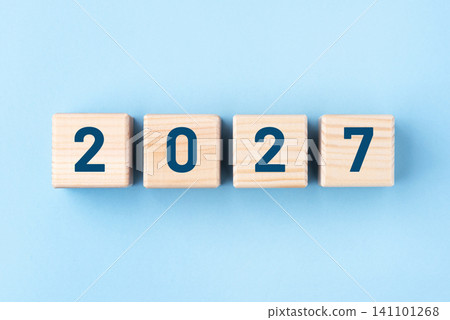 Wooden cubes with numbers of the New Year 2027 on a blue background Wooden cubes with numbers of the New Year 2027 on a blue background 141101268