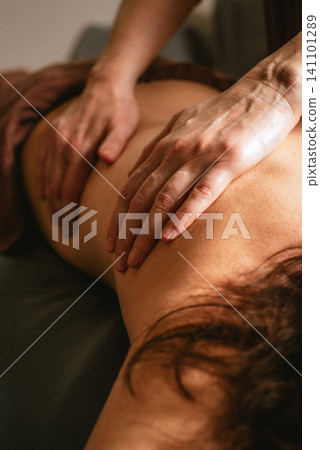 Back massage with hands close-up Back massage with hands close-up 141101289