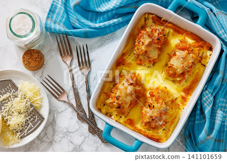 Cheesy Veggie Baked White Fish in blue baking dish Cheesy Veggie Baked White Fish in blue baking dish 141101659