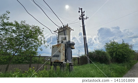Rural electrical transformer substation and power distribution lines supplying energy to countryside community. essential public utilities. Rural electrical transformer substation and power distribution lines supplying energy to countryside community. essential public utilities. 141101809