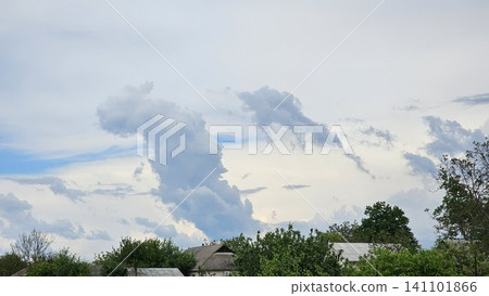Spectacular volumetric clouds above rural houses creating dramatic and dreamlike countryside sky landscape Spectacular volumetric clouds above rural houses creating dramatic and dreamlike countryside sky landscape 141101866