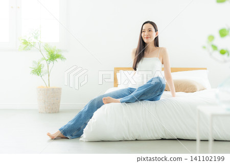 A woman relaxing in the bedroom A woman relaxing in the bedroom 141102199