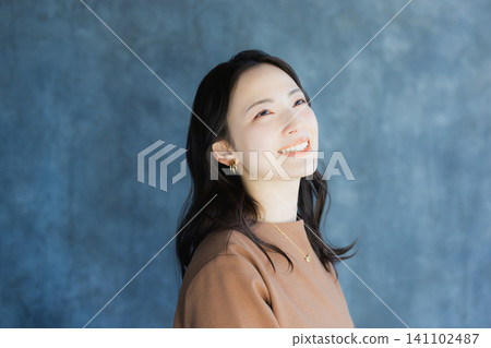 A woman smiling with a cheek A woman smiling with a cheek 141102487