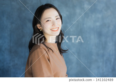 A woman smiling with a cheek A woman smiling with a cheek 141102489