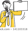 A male employee speaking into a microphone while holding a flip chart. 141103318