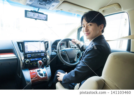 A young businessman driving 141103460