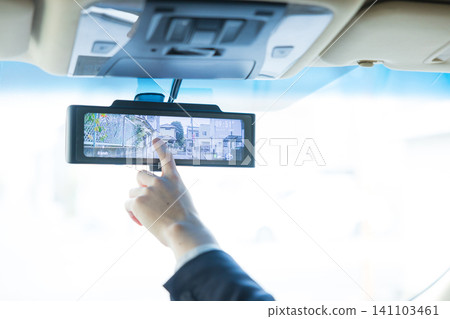 A young businessman driving A young businessman driving 141103461
