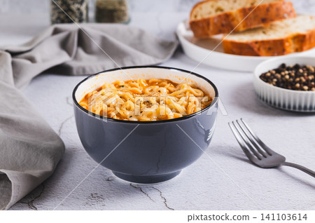 Hot Korean ramen with melted cheese in a bowl on the table Hot Korean ramen with melted cheese in a bowl on the table 141103614
