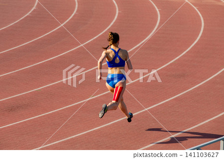 Female athlete with kinesio tape on back of her thigh Female athlete with kinesio tape on back of her thigh 141103627