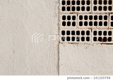 White Painted Wall with Exposed Perforated Bricks White Painted Wall with Exposed Perforated Bricks 141103749