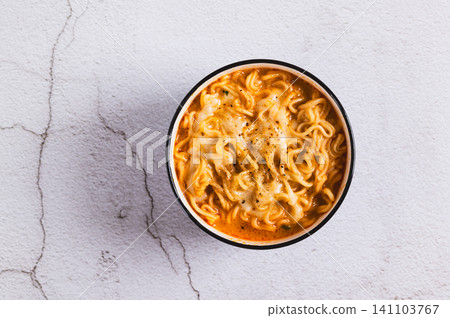 Close up of hot Korean ramen with melted cheese in a bowl on the table top view 141103767