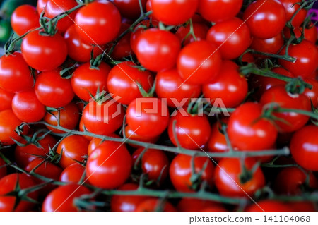 red cherry tomatoes at market. vibrant cluster of ripe, red cherry tomatoes red cherry tomatoes at market. vibrant cluster of ripe, red cherry tomatoes 141104068
