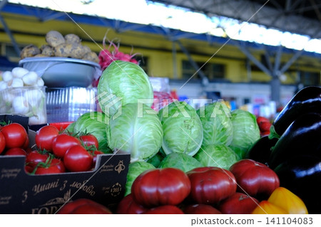 Fresh cabbage displayed at local market with eggplants tomatoes mushrooms and potatoes colorful farm vegetables and healthy seasonal produce Fresh cabbage displayed at local market with eggplants tomatoes mushrooms and potatoes colorful farm vegetables and healthy seasonal produce 141104083