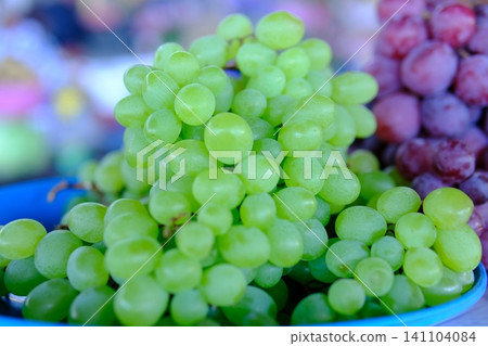 green and blue grapes. Fresh green and purple grapes displayed at local market healthy seasonal fruit and natural food green and blue grapes. Fresh green and purple grapes displayed at local market healthy seasonal fruit and natural food 141104084