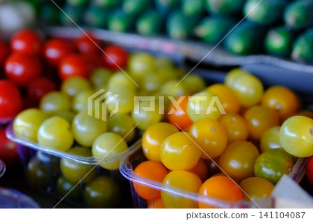 yellow tomatoes at the market. Fresh yellow tomatoes in a clear glass bowl yellow tomatoes at the market. Fresh yellow tomatoes in a clear glass bowl 141104087