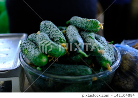 cucumbers in a bowl. cucumbers in a white bowl on the background of nature cucumbers in a bowl. cucumbers in a white bowl on the background of nature 141104094
