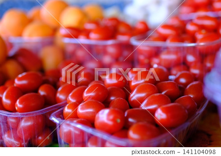 red cherry tomatoes at market. vibrant cluster of ripe, red cherry tomatoes red cherry tomatoes at market. vibrant cluster of ripe, red cherry tomatoes 141104098
