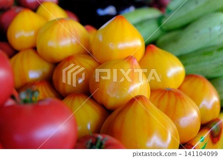 yellow tomatoes at the market. Fresh yellow tomatoes in a clear glass bowl yellow tomatoes at the market. Fresh yellow tomatoes in a clear glass bowl 141104099