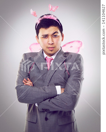 Studio, portrait and man as fairy for magic in Halloween party of startup up business and company. Adult, guy and male person with professional suit, costume and frown on face with arms crossed Studio, portrait and man as fairy for magic in Halloween party of startup up business and company. Adult, guy and male person with professional suit, costume and frown on face with arms crossed 141104627