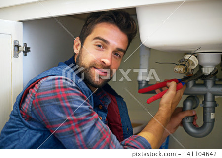Man, portrait and plumber with wrench for pipe repair, service or fix in home maintenance or indoor leak. Male person or handyman smile with water damage or sink of plumbing professional at the house Man, portrait and plumber with wrench for pipe repair, service or fix in home maintenance or indoor leak. Male person or handyman smile with water damage or sink of plumbing professional at the house 141104642