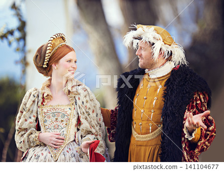 Medieval, king and couple in history with renaissance fashion outdoor with marriage and love. Vintage, garden and royal leader with queen together on a lawn with conversation and theater costume Medieval, king and couple in history with renaissance fashion outdoor with marriage and love. Vintage, garden and royal leader with queen together on a lawn with conversation and theater costume 141104677