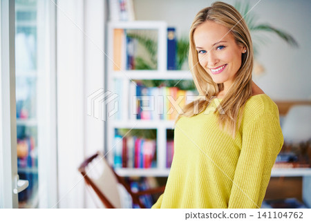 Portrait, smile and woman in a home library for weekend reading, relax or stress relief in house. Book shelf, face and female person in study room for me time, novel or chilling on weekend or day off 141104762