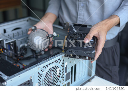 Close up of electronic technician hands working on computer repair. 141104891