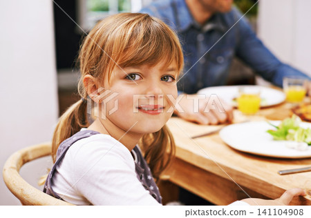 Girl, child and smile in portrait at dinner table for eating, food and relax on holiday in family house. Kid, happy and people in dining room for lunch with nutrition, diet and together in home Girl, child and smile in portrait at dinner table for eating, food and relax on holiday in family house. Kid, happy and people in dining room for lunch with nutrition, diet and together in home 141104908