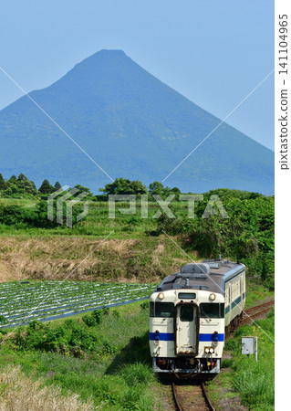 A train on the Ibusuki-Makurazaki Line running with Mount Kaimon in the background. A train on the Ibusuki-Makurazaki Line running with Mount Kaimon in the background. 141104965