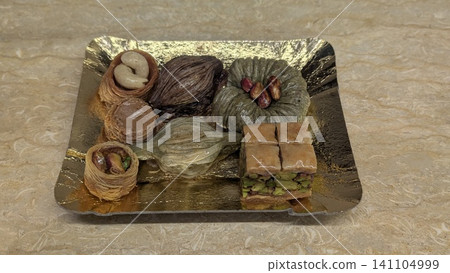 Various unique shapes of Egyptian pastry sweets with pistachios and nuts on a try Various unique shapes of Egyptian pastry sweets with pistachios and nuts on a try 141104999
