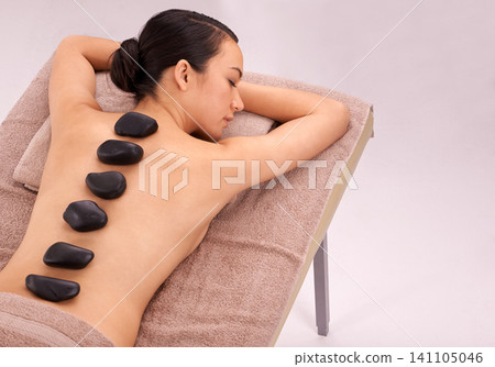 Spa, woman and massage with hot stone therapy and wellness with vacation and stress relief. Natural, person and girl with peace or calm with holiday and weekend break with skin detox or luxury resort Spa, woman and massage with hot stone therapy and wellness with vacation and stress relief. Natural, person and girl with peace or calm with holiday and weekend break with skin detox or luxury resort 141105046
