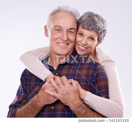 Love, hug and portrait of senior couple on a white background for bonding, affection and loving relationship. Marriage, happy and mature man and woman embrace for commitment, trust and care in studio 141105193