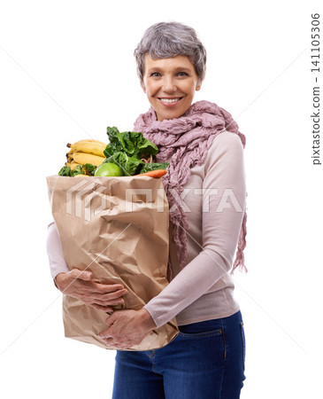 Woman, paper bag and portrait with vegetables for shopping, groceries and consumer for nutrition and fruits in studio. Mature lady, happy and hold produce for health and food on white backdrop Woman, paper bag and portrait with vegetables for shopping, groceries and consumer for nutrition and fruits in studio. Mature lady, happy and hold produce for health and food on white backdrop 141105306
