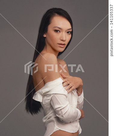 Portrait, shirt and beauty with woman, fashion and confident girl on a grey studio background. Face, person and model with stylish lingerie and mockup space with pride, aesthetic and casual outfit 141105337