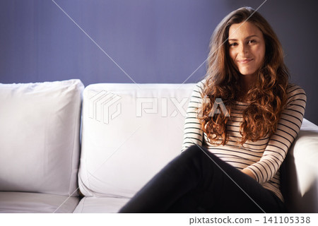 Woman, sofa and portrait in a home relax with smile on break in a living room. Couch, lounge and happy female person with confidence and casual fashion and clothing in new house or condo with mockup 141105338