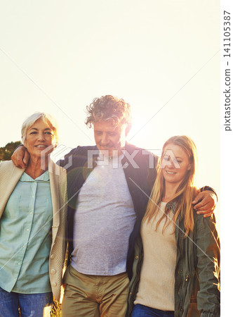 Sunset, nature and senior parents with daughter for adventure, hiking and walking outdoors. Family, travel and mature mother, father and woman embrace on holiday, vacation and weekend together 141105387
